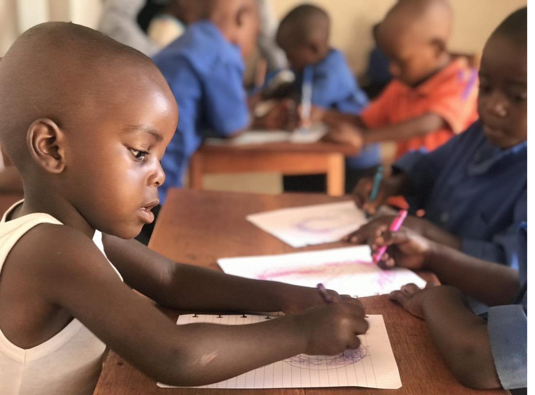 A preschool child practicing writing